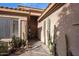 Front entrance with a wood door and desert landscaping including cacti and stone at 7654 E Quill Ln, Scottsdale, AZ 85255