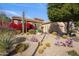 Landscaped front yard with desert plants and cacti surrounding a tan single-story home at 7654 E Quill Ln, Scottsdale, AZ 85255