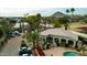 Aerial view of the condo complex featuring mature landscaping, a pool and views of Camelback Mountain at 7777 E 2Nd St # 101, Scottsdale, AZ 85251