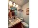 Well-lit bathroom featuring a modern sink, vanity, and decorative mirror at 7777 E 2Nd St # 101, Scottsdale, AZ 85251