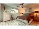 Comfortable bedroom with large window, a ceiling fan and brick-patterned tile floor at 7777 E 2Nd St # 101, Scottsdale, AZ 85251