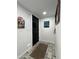 Interior hallway with a black door, decor, rug, and tile flooring at 7777 E 2Nd St # 101, Scottsdale, AZ 85251