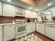 Well-lit kitchen featuring white cabinetry, modern appliances, and tiled backsplash at 7777 E 2Nd St # 101, Scottsdale, AZ 85251