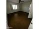 Spacious bedroom with dark brown flooring and window at 801 W Earll Dr, Phoenix, AZ 85013