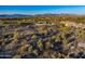 Aerial view of a desert lot with mountain views and surrounding homes at 8055 E Sunset Sky Cir, Scottsdale, AZ 85266