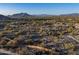 Aerial view showing a desert lot with neighboring houses and mountain backdrop at 8055 E Sunset Sky Cir, Scottsdale, AZ 85266