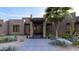 Front entrance of a modern home featuring a stone walkway and glass doors at 8055 E Sunset Sky Cir, Scottsdale, AZ 85266