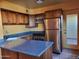 Modern kitchen featuring stainless steel appliances and wood cabinets at 8221 E Garfield St # L122, Scottsdale, AZ 85257