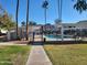 Community swimming pool with covered seating area at 8221 E Garfield St # L122, Scottsdale, AZ 85257