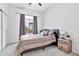 Cozy bedroom with a patterned bedspread and wood nightstand at 8334 E Inca St, Mesa, AZ 85207