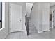 Elegant entryway with a white door and gray carpeted staircase at 8334 E Inca St, Mesa, AZ 85207