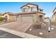 Two-story home with stone facade and a two-car garage at 8334 E Inca St, Mesa, AZ 85207