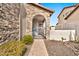 Stone and stucco exterior with arched entryway and gate at 8334 E Inca St, Mesa, AZ 85207