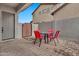 Private patio with brick pavers, red chairs, and small table at 8334 E Inca St, Mesa, AZ 85207