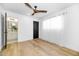 Simple bedroom with light walls, ceiling fan, and wood flooring at 8626 E Montebello Ave, Scottsdale, AZ 85250