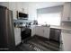 Modern kitchen with stainless steel appliances and white cabinets at 903 W Loughlin Dr, Chandler, AZ 85225