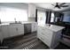 Modern kitchen island with white cabinets and quartz countertops at 903 W Loughlin Dr, Chandler, AZ 85225