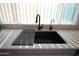 Modern kitchen sink with black matte faucet and stainless steel drying rack at 903 W Loughlin Dr, Chandler, AZ 85225