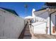 Backyard with a white brick wall, a white tent, and lush greenery at 941 W Peralta Ave, Mesa, AZ 85210