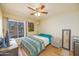 Bright bedroom featuring hardwood floors, ceiling fan, and natural light at 941 W Peralta Ave, Mesa, AZ 85210