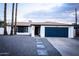 White brick house with a blue garage door and landscaped front yard at 941 W Peralta Ave, Mesa, AZ 85210