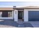 Close-up of front entrance with dark front door, white brick pillars and dark garage door at 941 W Peralta Ave, Mesa, AZ 85210