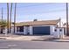 A well-maintained single story home with dark garage door and neat landscaping at 941 W Peralta Ave, Mesa, AZ 85210