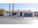 Charming single-story home with white brick, a dark garage door, and well-maintained landscaping at 941 W Peralta Ave, Mesa, AZ 85210