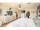 Spacious main bedroom with a ceiling fan, dresser and a glimpse into the bathroom at 941 W Peralta Ave, Mesa, AZ 85210