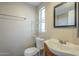 Functional bathroom featuring a toilet, sink, and a mirror that shows a shower at 9431 E Coralbell Ave # 198, Mesa, AZ 85208