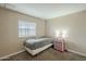 Well-lit bedroom with neutral textures, comfortable bed, carpeted floor, and decorative nightstand at 9431 E Coralbell Ave # 198, Mesa, AZ 85208