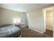 Comfortable bedroom showcasing neutral tones, including carpet, an inviting bed, and a decorative nightstand at 9431 E Coralbell Ave # 198, Mesa, AZ 85208