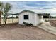 Front view of a white manufactured home with carport and small landscaping at 9431 E Coralbell Ave, Mesa, AZ 85208