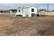 Side view of a white manufactured home with gravel landscaping at 9431 E Coralbell Ave, Mesa, AZ 85208