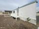 Side view of a white manufactured home with ramp and gravel landscaping at 9431 E Coralbell Ave, Mesa, AZ 85208