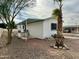 Side view of a white manufactured home with palm tree and gravel landscaping at 9431 E Coralbell Ave, Mesa, AZ 85208