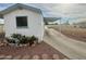 Single-wide mobile home with carport and landscaping at 9431 E Coralbell Ave, Mesa, AZ 85208