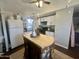 Bright kitchen with white cabinets, center island, and modern appliances at 9431 E Coralbell Ave, Mesa, AZ 85208