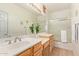 Bright bathroom with a single vanity and shower/tub combo at 9862 E Flower Ave, Mesa, AZ 85208