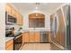 Kitchen with light wood cabinets and stainless steel appliances at 9862 E Flower Ave, Mesa, AZ 85208