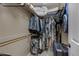 Large bedroom closet with hanging rods and shelving at 10101 N Arabian Trl # 2052, Scottsdale, AZ 85258