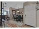 Small dining area with round wooden table and four chairs, near entry at 10101 N Arabian Trl # 2052, Scottsdale, AZ 85258