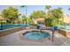 Community hot tub with surrounding lounge chairs and tennis courts nearby at 10101 N Arabian Trl # 2052, Scottsdale, AZ 85258