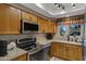 Condo kitchen with wood cabinets, stainless steel appliances at 10101 N Arabian Trl # 2052, Scottsdale, AZ 85258