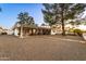 Spacious backyard with covered patio and gravel landscaping at 10242 E Spring Creek Rd, Sun Lakes, AZ 85248