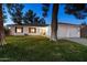Ranch style home with 2-car garage, mature trees, and well-manicured lawn at 10242 E Spring Creek Rd, Sun Lakes, AZ 85248