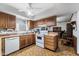 Kitchen with wood cabinets, tile floor, and white appliances at 10242 E Spring Creek Rd, Sun Lakes, AZ 85248
