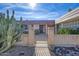 Front entry with wrought iron gate and brick wall at 10625 W Deanne Dr, Sun City, AZ 85351