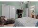 Bedroom with chaise lounge, TV, and ensuite bathroom at 12519 W Bajada Rd, Peoria, AZ 85383