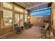 Relaxing covered patio with seating area and access to the backyard at 12519 W Bajada Rd, Peoria, AZ 85383
